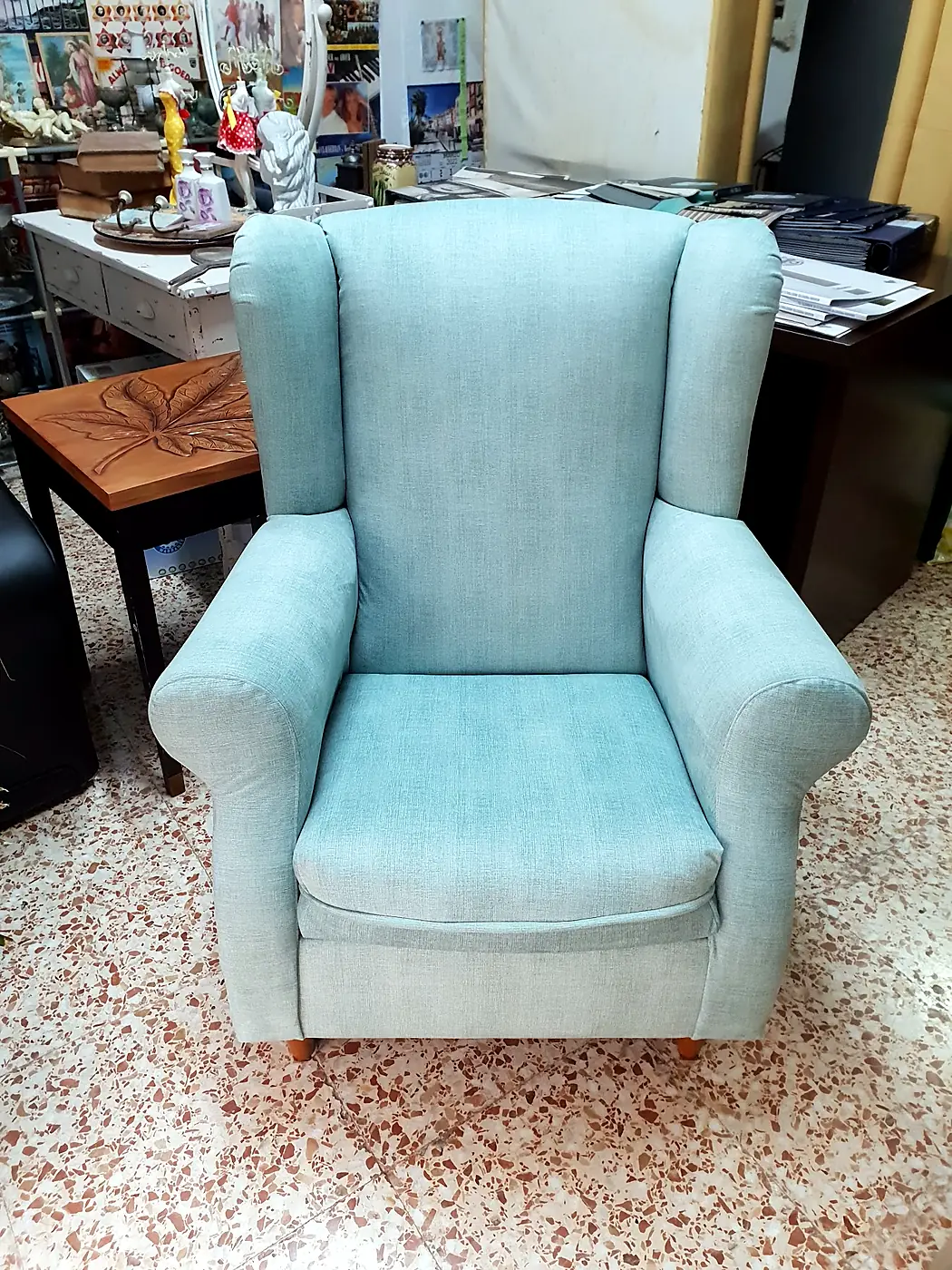 Wingback chair upholstered in pale aqua