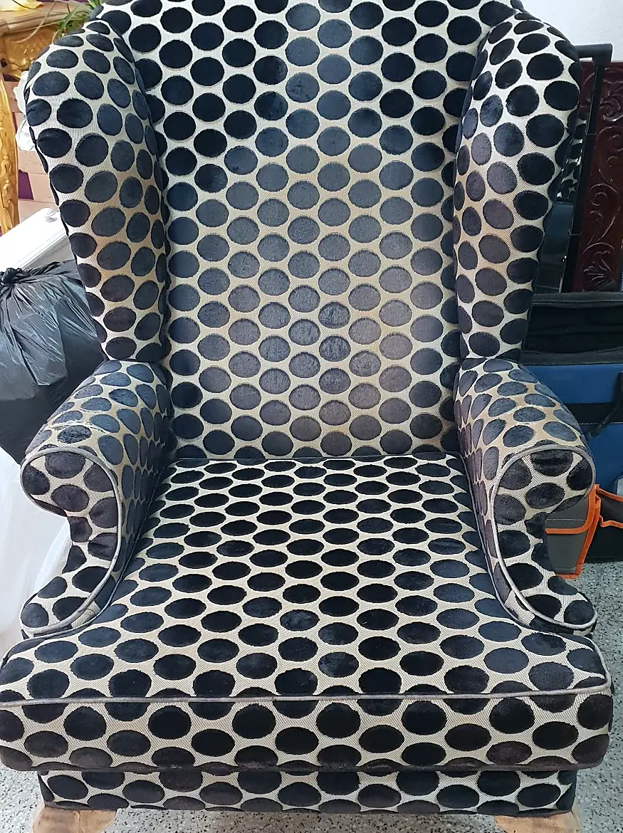 Wingback chair upholstered in navy polka-dot fabric