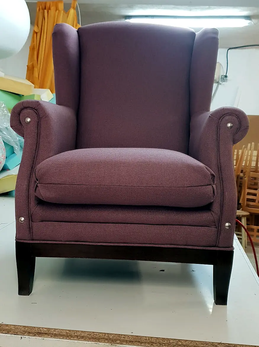 Wingback chair upholstered in mauve