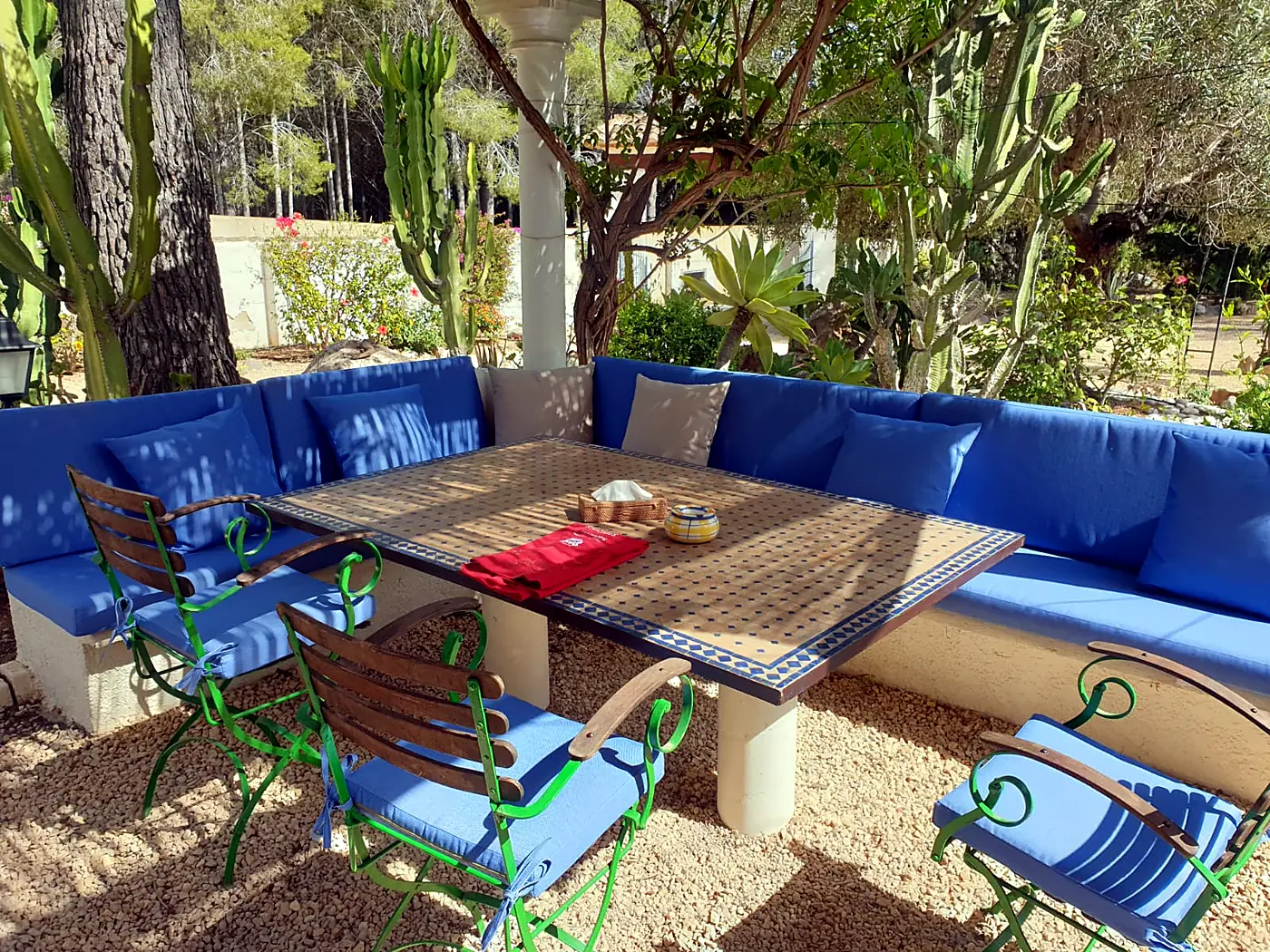 Built-in benches with blue cushions on a garden terrace
